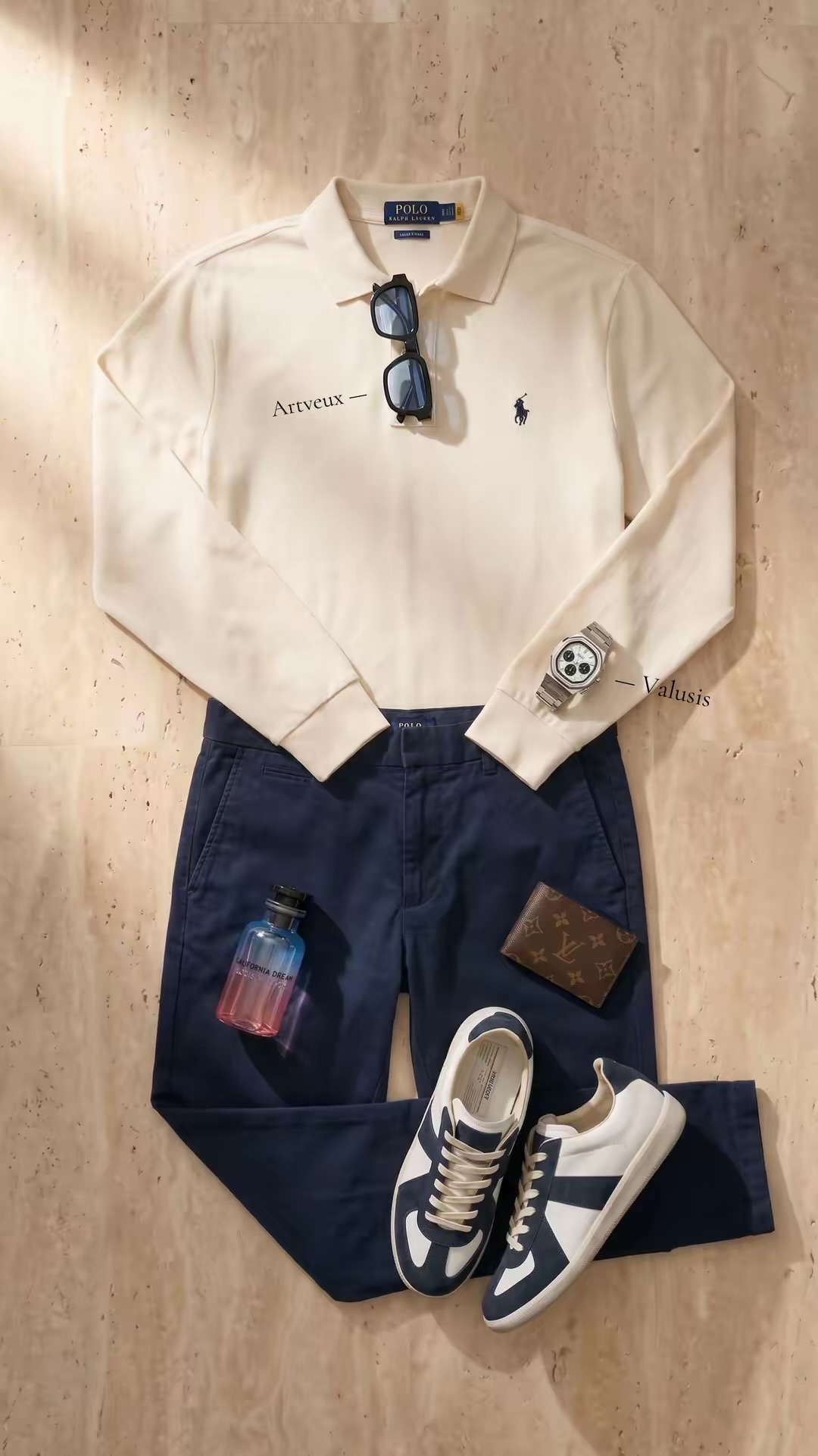 Flat-lay: Artveux cream polo, navy trousers, Valusis watch and Louis Vuitton wallet